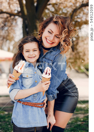 Cute and stylish family in a spring park Cute and stylish family in a spring park 54912099