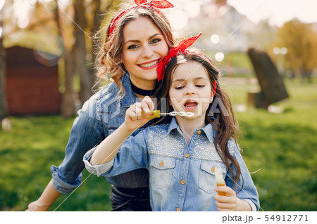 Cute and stylish family in a spring park 54912771