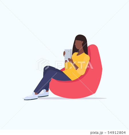 woman sitting in bean bag armchair african american girl freelancer or office worker using digital 54912804
