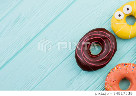 Three different donuts and copy space. Three different donuts and copy space. 54917339