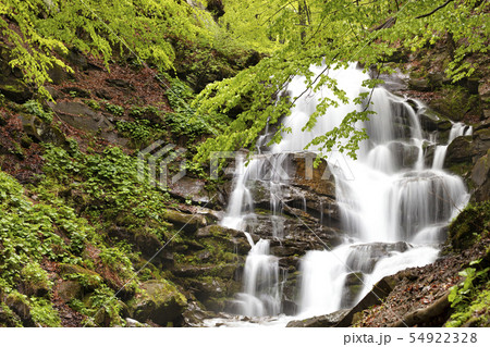 Powerful waterfall on the mountain river. Powerful waterfall on the mountain river. 54922328