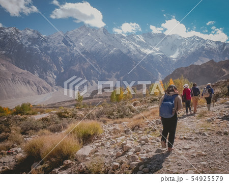 People walking along the track in Passu. 54925579