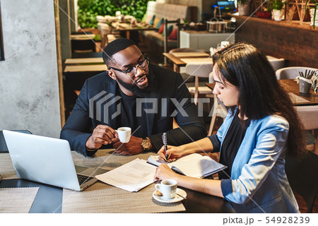 You'll be happier at work when you make some friends there. Two colleagues having lunch in company's 54928239