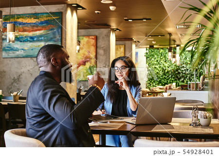 Be true to your work, your word, and your friend. Serious woman listening to her colleague during 54928401