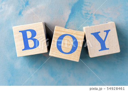 Wooden cubes with word BOY on blue table. Wooden cubes with word BOY on blue table. 54928461