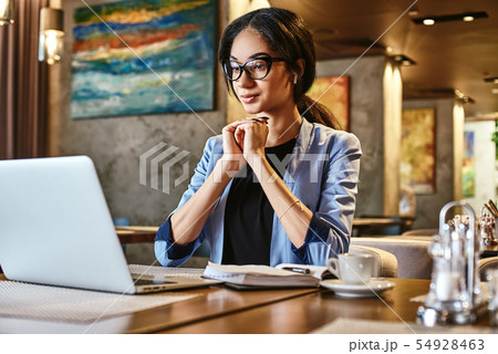 Success is no accident. Young businesswoman sitting in cafe in front of laptop and networking Success is no accident. Young businesswoman sitting in cafe in front of laptop and networking 54928463