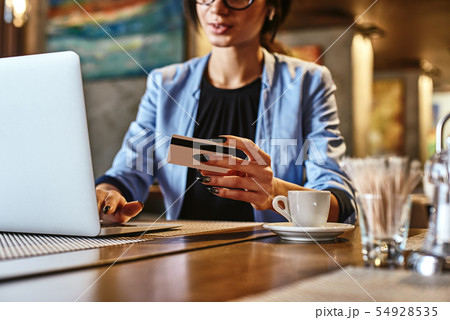 Money often costs too much. Mixed race busy woman using credit card for shopping and paying bills on Money often costs too much. Mixed race busy woman using credit card for shopping and paying bills on 54928535