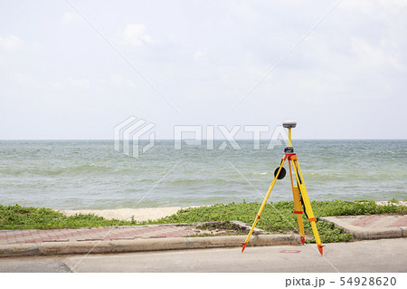 GPS surveying in field sea background, Global 54928620