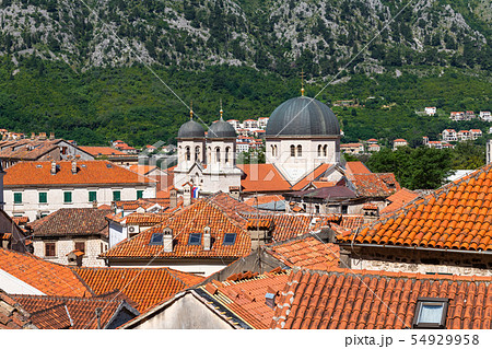 Red tiled roofs of old town houses in Kotor and Serbian Orthodox Church of St. Nikola , Montenegro Red tiled roofs of old town houses in Kotor and Serbian Orthodox Church of St. Nikola , Montenegro 54929958