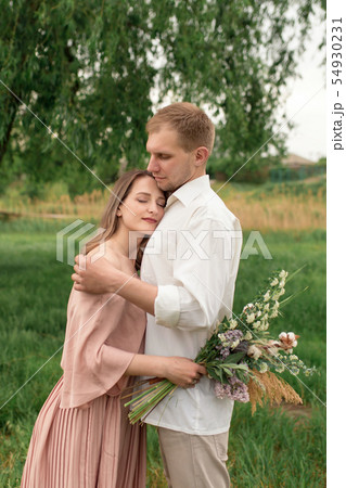 Young loving couple hugging and dancing on the Young loving couple hugging and dancing on the 54930231