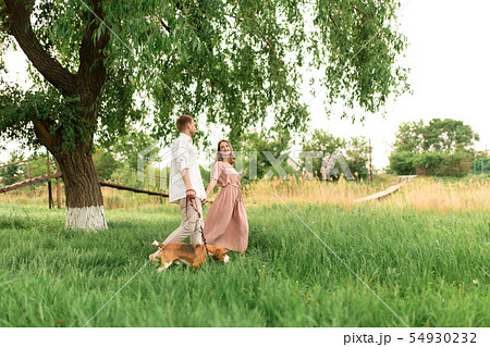 Young loving couple having fun and running on the Young loving couple having fun and running on the 54930232