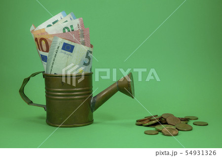 Euro banknotes in a copper watering can 54931326