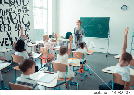 Maths teacher reading a mathematical problem in the classroom. 54932283