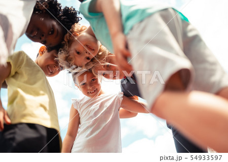 Group of children talking leaning forward to each other. 54933597