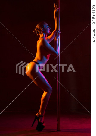 Naked flexible woman dancing passionately at pylon Naked flexible woman dancing passionately at pylon 54934308