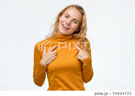 Happy young teenager woman pointing fingers at herself. 54934725