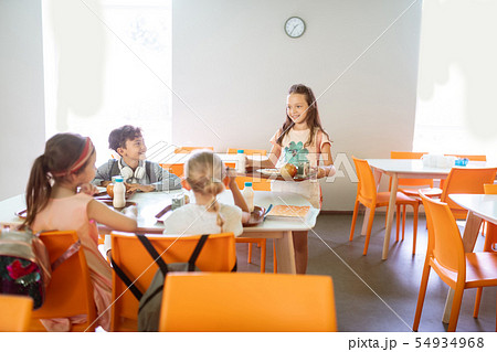 Cute good-looking children having lunch at school together Cute good-looking children having lunch at school together 54934968