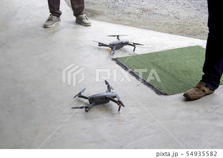 Black 2 drone on concrete floor and copy space. Black 2 drone on concrete floor and copy space. 54935582