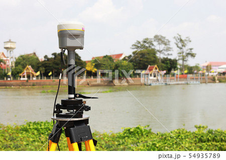 GPS surveying in field sea background, Global 54935789