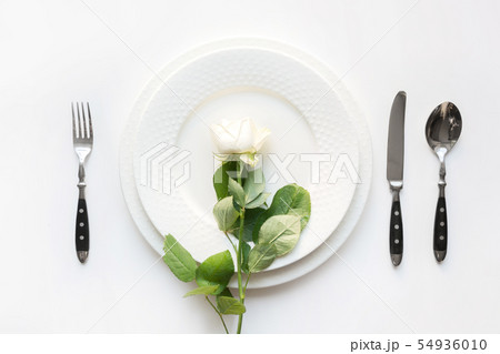 White table setting with rose. White table setting with rose. 54936010