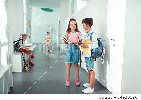 Dark-haired brother and sister having their first day at school Dark-haired brother and sister having their first day at school 54936526