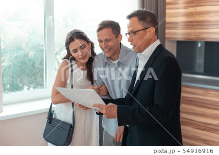 Couple speaking with realtor while choosing the house 54936916