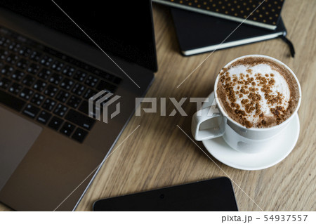 notebooks with laptop and coffee cup on the desk notebooks with laptop and coffee cup on the desk 54937557