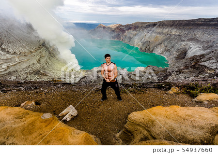 Young man in the crater of a volcano 54937660