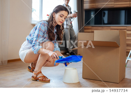 Wife unpacking the box while moving to apartment with husband 54937734