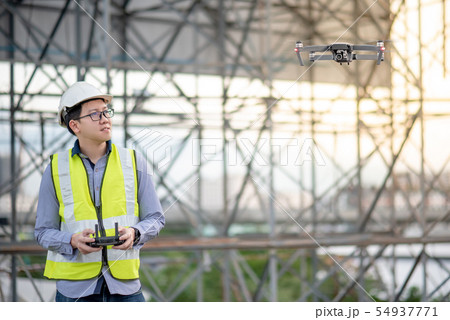 Asian engineer flying drone over construction site 54937771