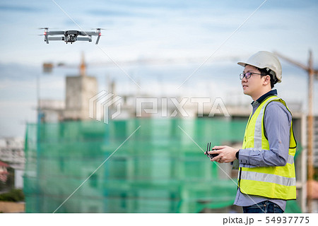 Asian engineer flying drone over construction site 54937775