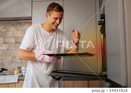 Husband feeling happy after baking amazing croissants 54937816