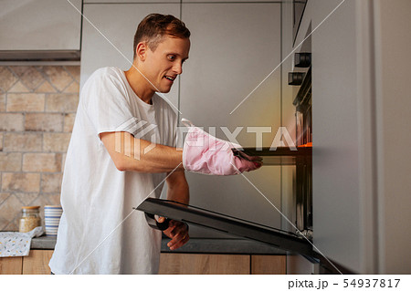 Loving handsome husband baking croissants in the morning Loving handsome husband baking croissants in the morning 54937817