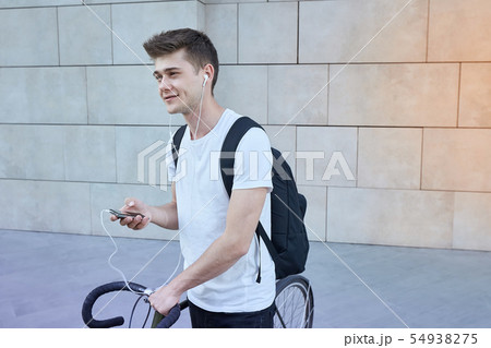 Handsome hipster man posing with bicycle in the city. 54938275