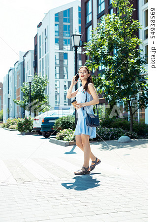 Beautiful woman wearing summer dress calling her husband Beautiful woman wearing summer dress calling her husband 54938569
