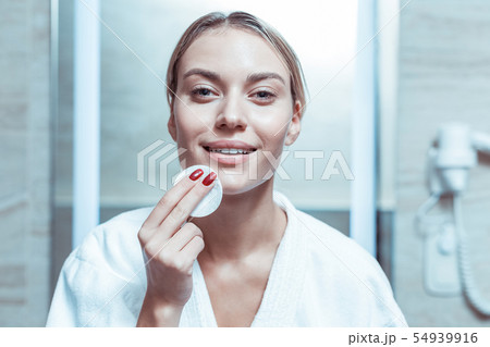 Beaming lady worrying about her skin state and being diligent 54939916