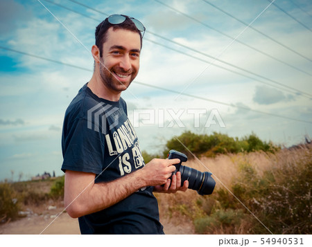 Happy young caucasian man photographer 54940531