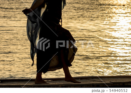 Beautiful silhouette at sunset golden sea water 54940552