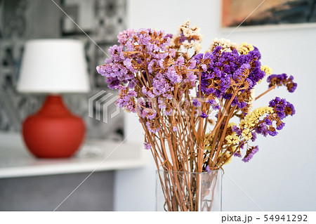 Pretty violet flowers in glass vase at home 54941292