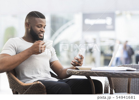 African american guy having free time to drink coffe African american guy having free time to drink coffe 54941681