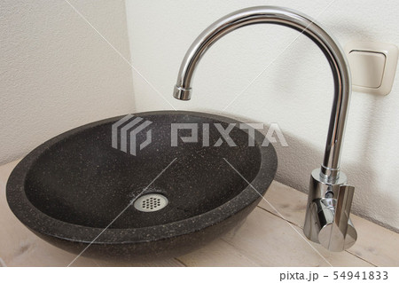 Wooden table with a stone sink, stylish sink bathroom design Wooden table with a stone sink, stylish sink bathroom design 54941833