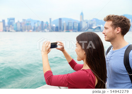 Tourist couple looking Victoria harbour Hong Kong Tourist couple looking Victoria harbour Hong Kong 54942279