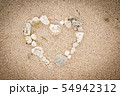 Shells on the ocean beach, heart shape background 54942312