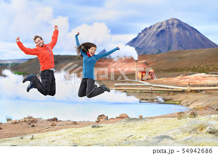 Iceland travel people jumping of joy in nature Iceland travel people jumping of joy in nature 54942686