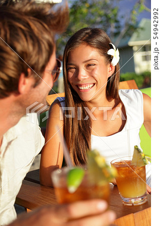 Romantic couple enjoying drinks at beach club Romantic couple enjoying drinks at beach club 54942992