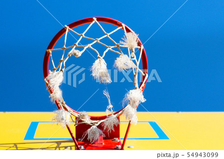 Red basketball hoop against a blue sky Red basketball hoop against a blue sky 54943099