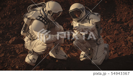 Astronauts collecting rock samples on Mars Astronauts collecting rock samples on Mars 54943367