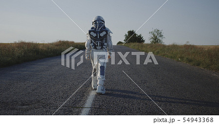Astronaut walking on road Astronaut walking on road 54943368