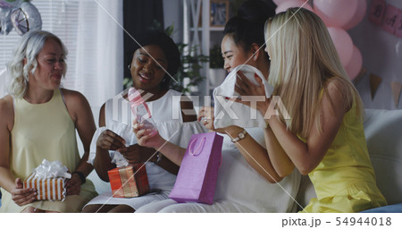 Friends celebrating young mother 54944018