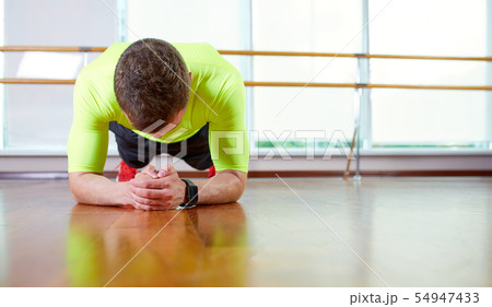 Plank it Confident muscled young man wearing sport wear and doing plank position while exercising on 54947433